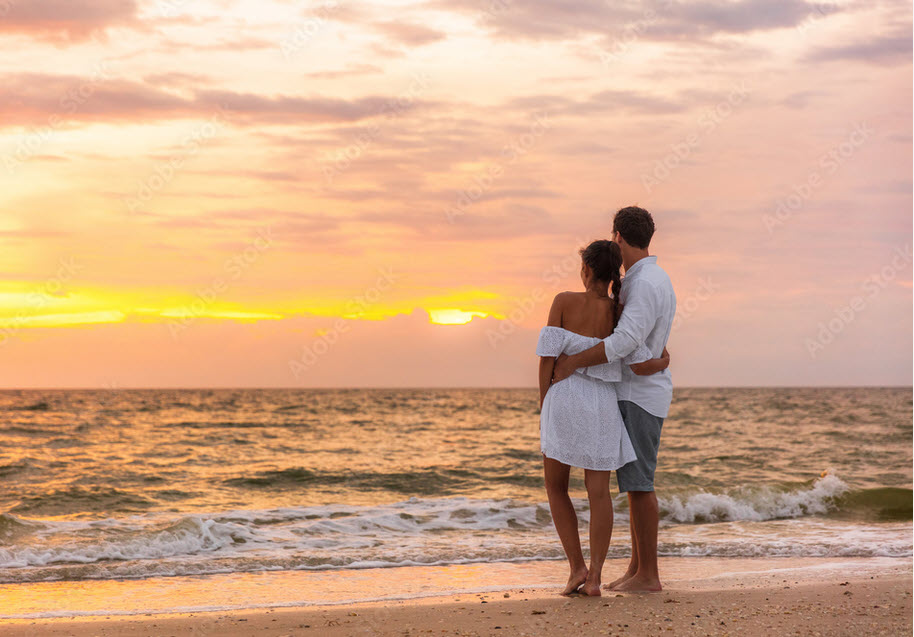carefree couple at sunset